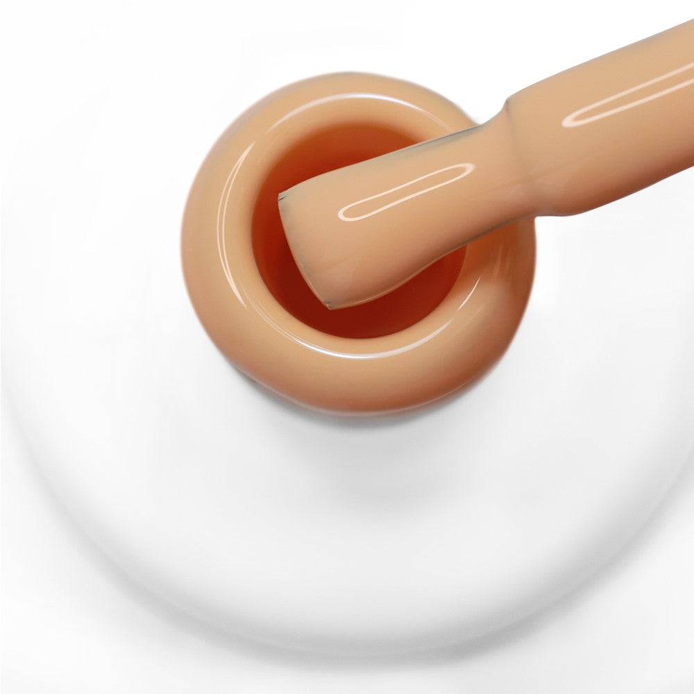 Pincel a sair do gargalo a mostrar a cor laranja