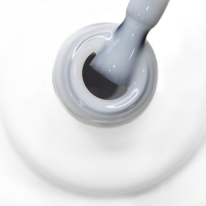 Boião branco visto de cima com gargalo e pincel a mostrar a cor