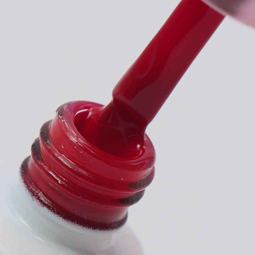 Pincel a ser retirado do boião com cor vermelha